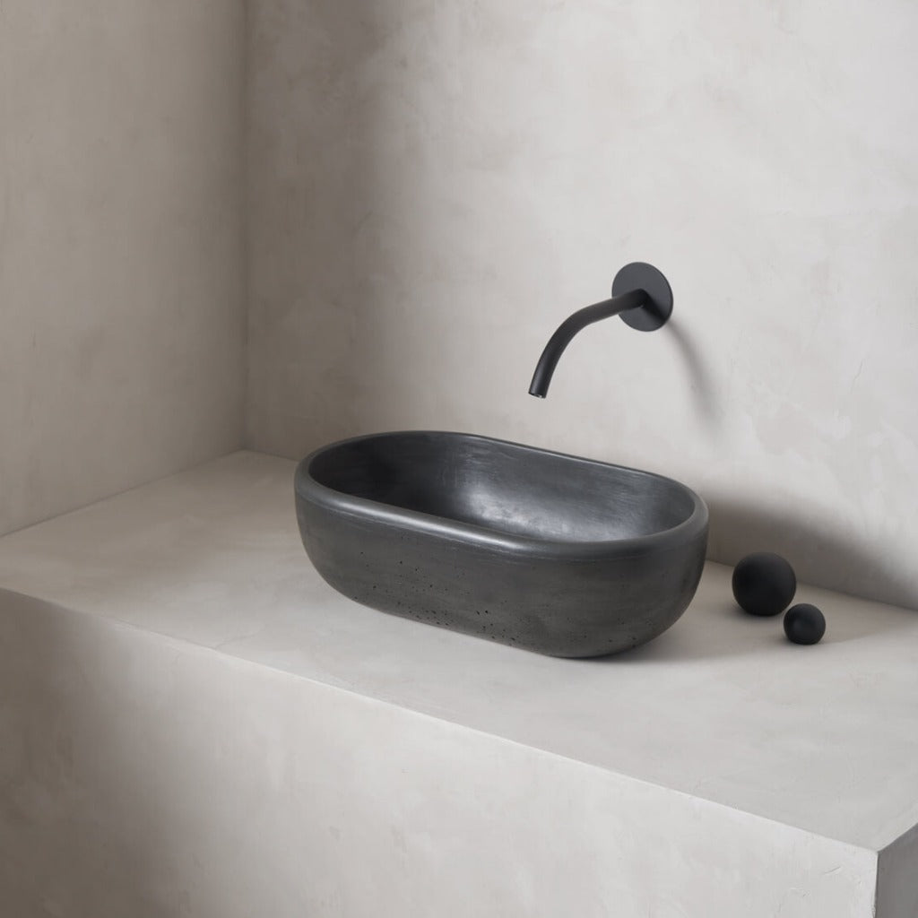 A petite and obround washbowl with softened curves and high, round-over basin walls