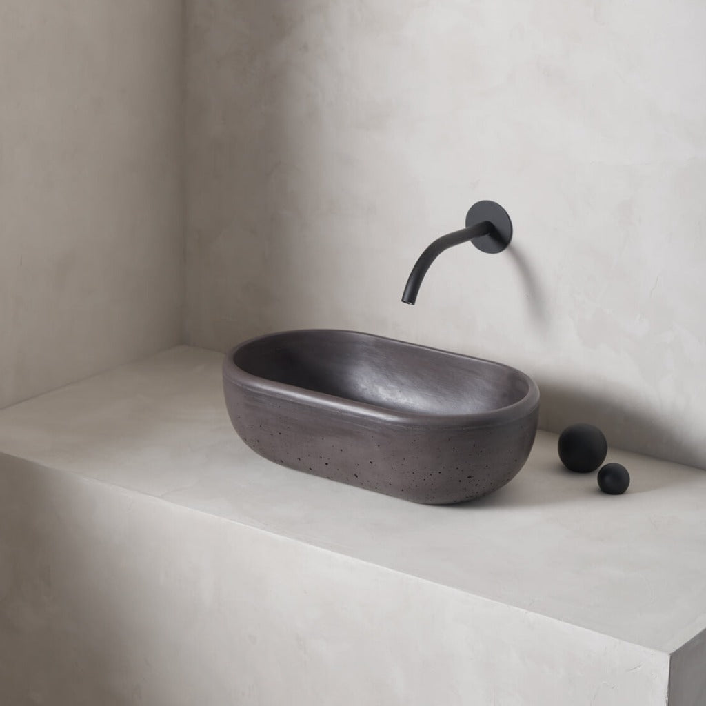 A petite and obround washbowl with softened curves and high, round-over basin walls