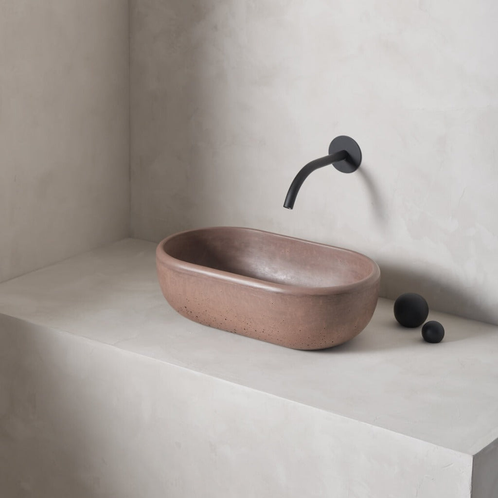 A petite and obround washbowl with softened curves and high, round-over basin walls