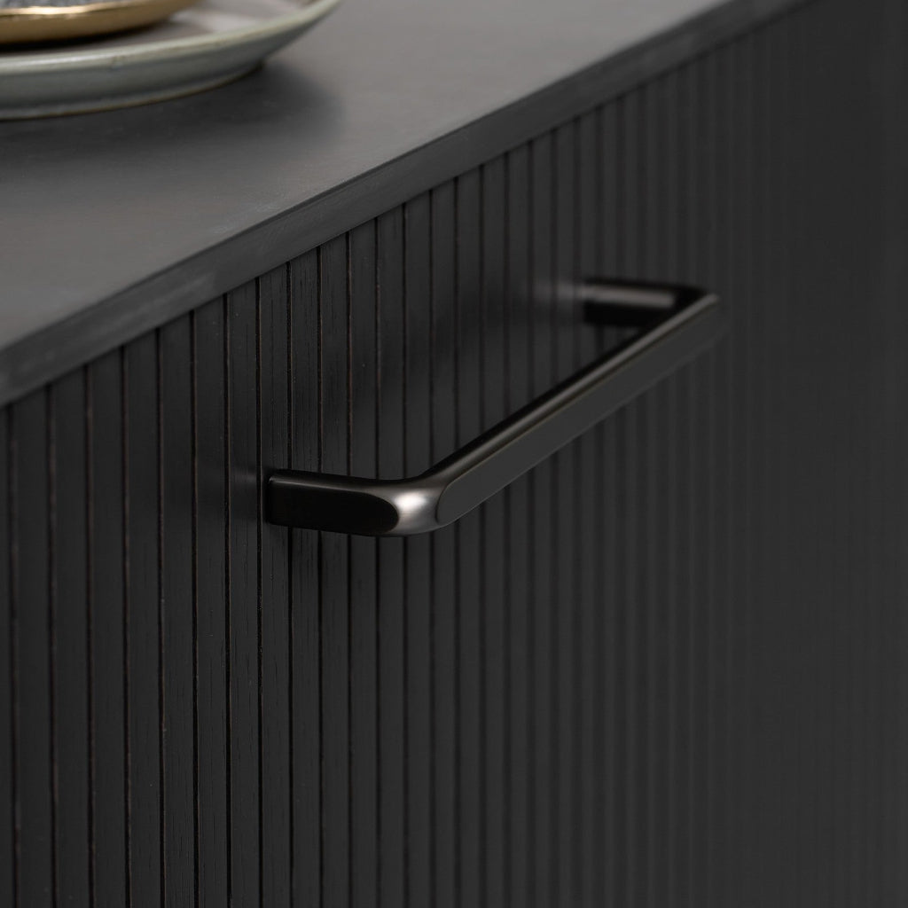 Gun metal Furnipart Unify cabinet handle, 160 mm, on a black fluted cabinet door under a dark countertop.
