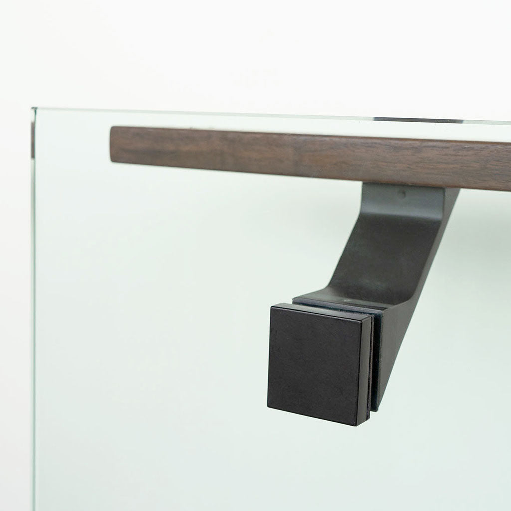 A close up of a Componance VS Glass Mounted Bracket on a door handle.