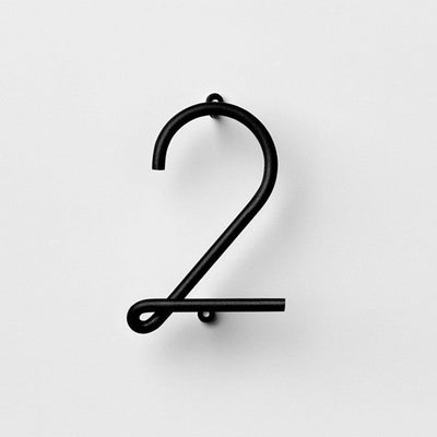 A NakNak black metal Wire Number Neutral two on a white background.