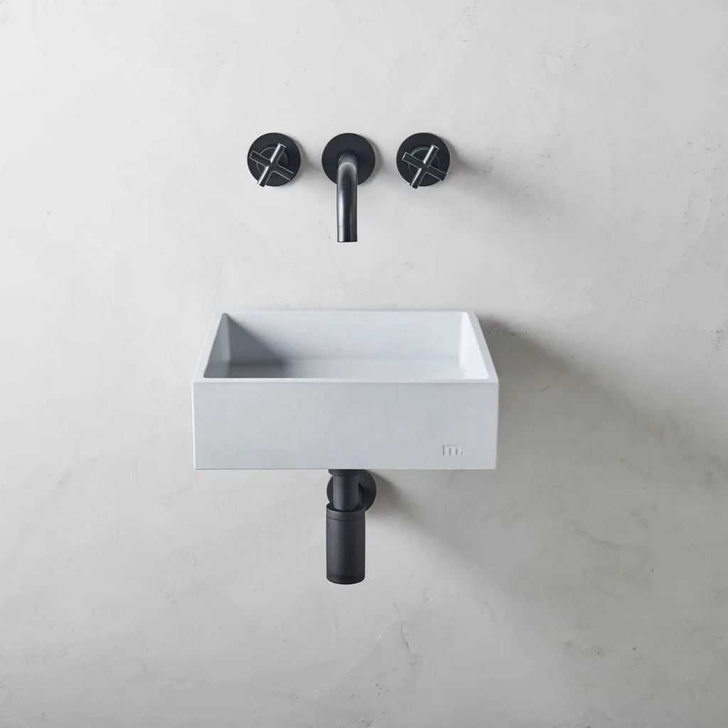 Square wash basin with pale grey finish affixed to wall