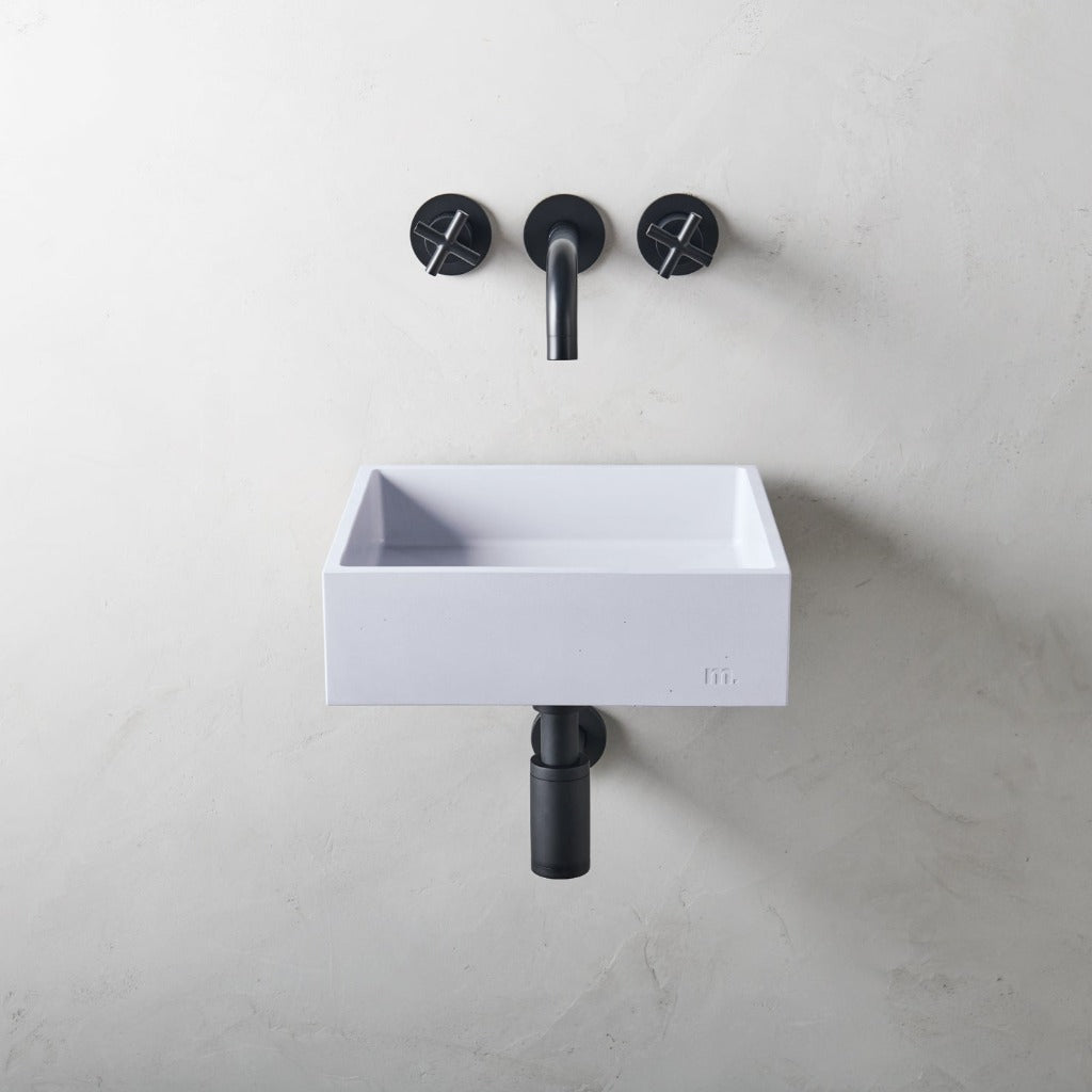 A mudd. concrete Yarra Basin SM Affix sink sitting next to a black faucet.
