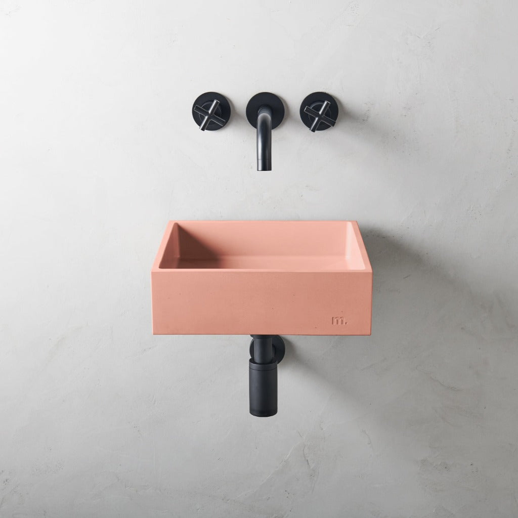 a mudd. concrete Yarra Basin SM Affix with a black faucet and a pink sink.