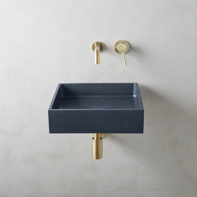 A mudd. concrete Yarra Basin LG Affix with a gold faucet and a blue square sink.