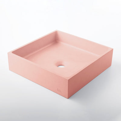 a pink Yarra Basin LG sink by mudd. concrete on a white surface.
