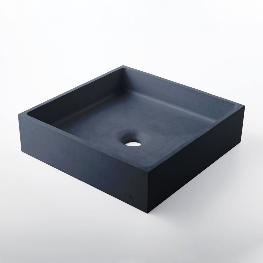 A black Yarra Basin LG sink with a hole in the middle by mudd. concrete.