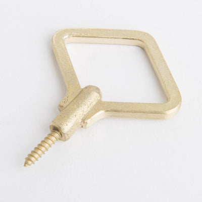 A Zenmai Brass Hooks by Oji Masanori with a screw in the middle.