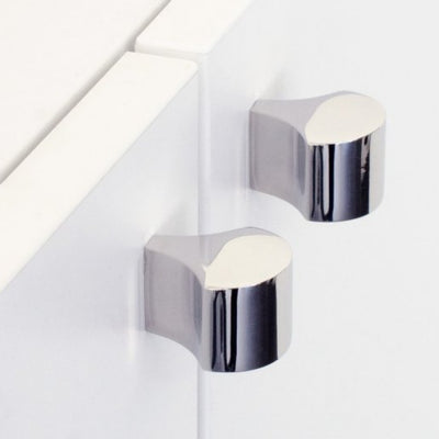 Polished stainless steel knobs mounted on cabinet