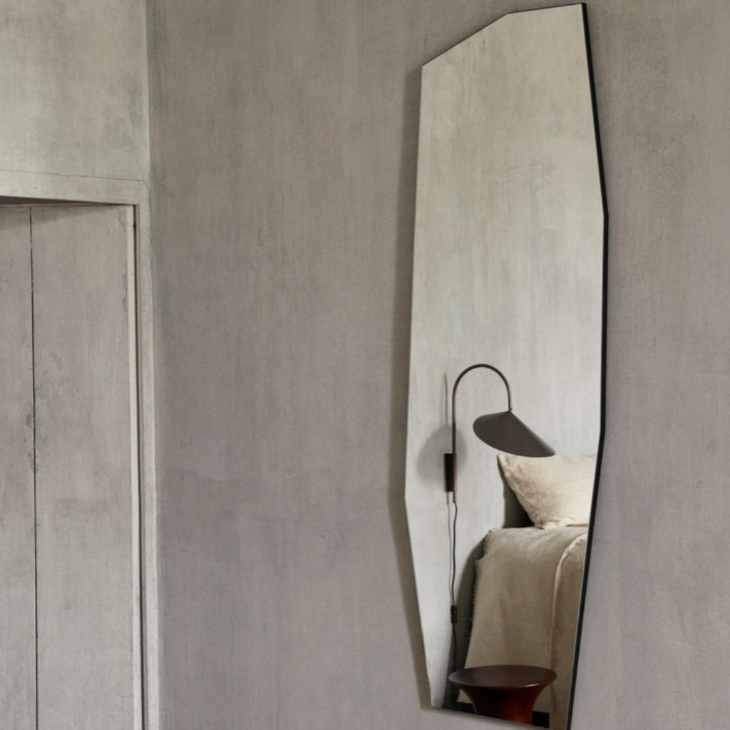 Shard mirror in large with black frame on grey wall in bedroom