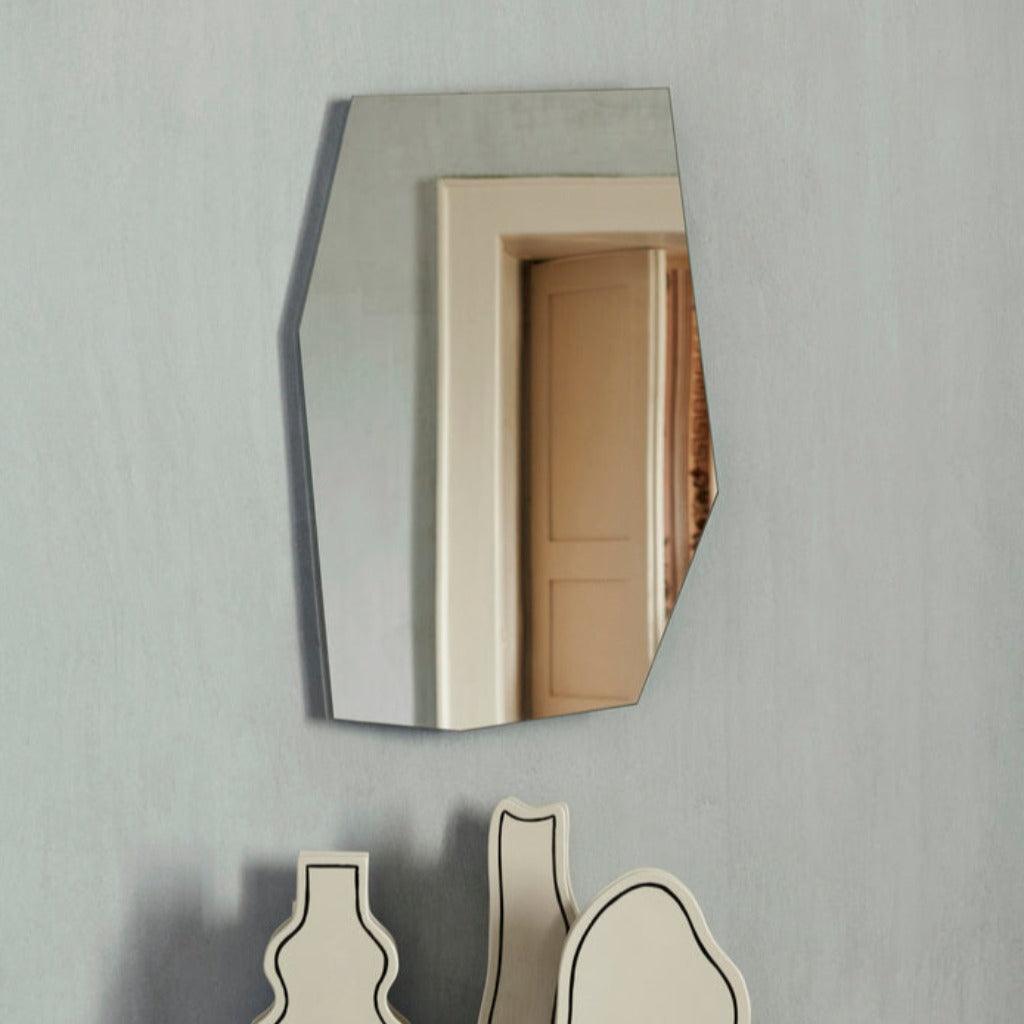 shard mirror hanging on grey wall