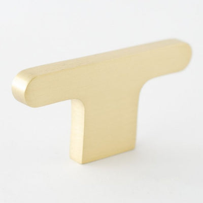 A T shaped knob in brushed brass