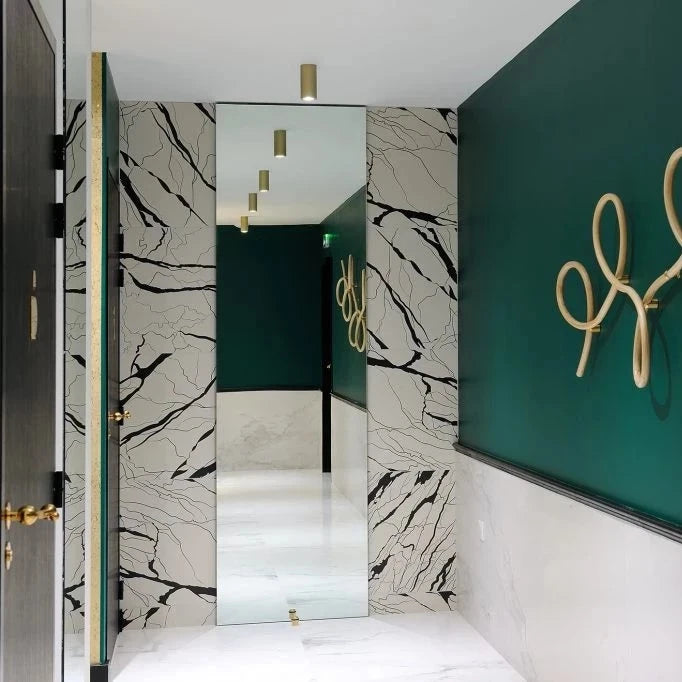 Vervloet Bubbles lever on a black door in a green and marble hallway.