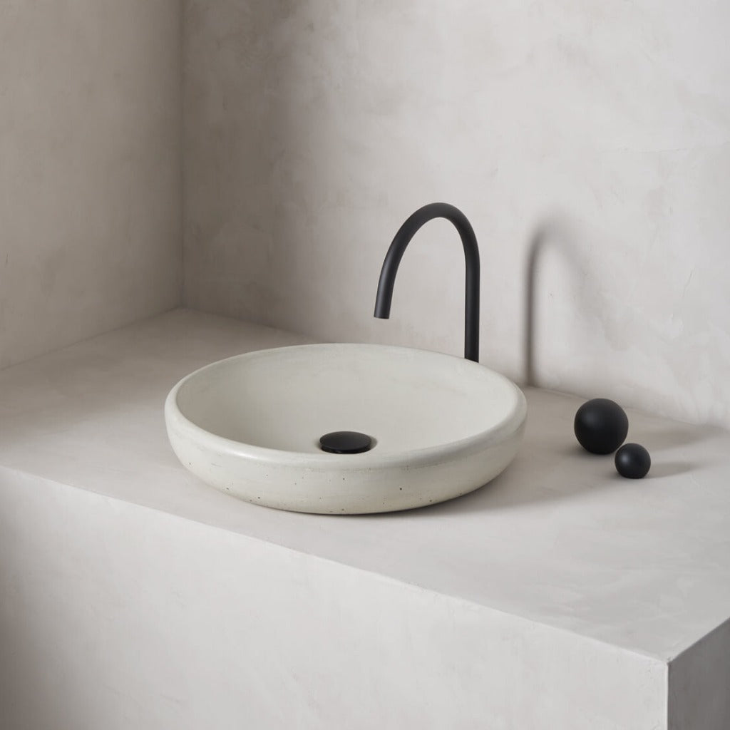 A large, circular washbowl with a gradual shallow slope and low-profile, round-over basin walls