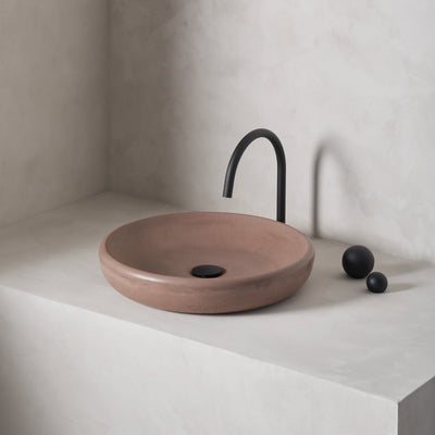 A large, circular washbowl with a gradual shallow slope and low-profile, round-over basin walls
