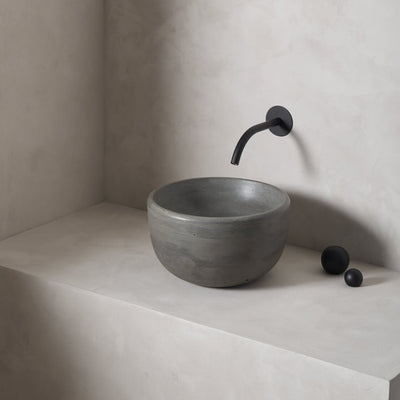 A petite and tall circular washbowl with an uplifted sink interior and round-over basin walls