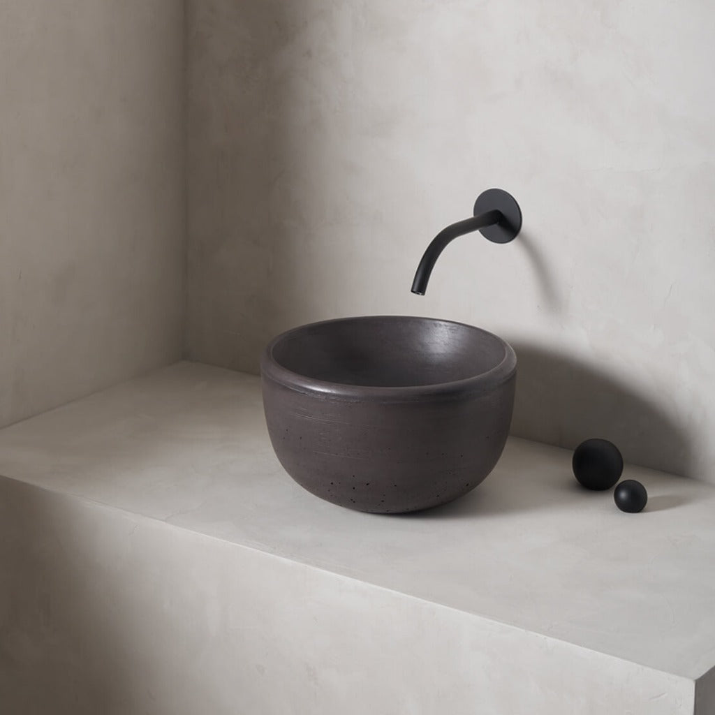 A petite and tall circular washbowl with an uplifted sink interior and round-over basin walls