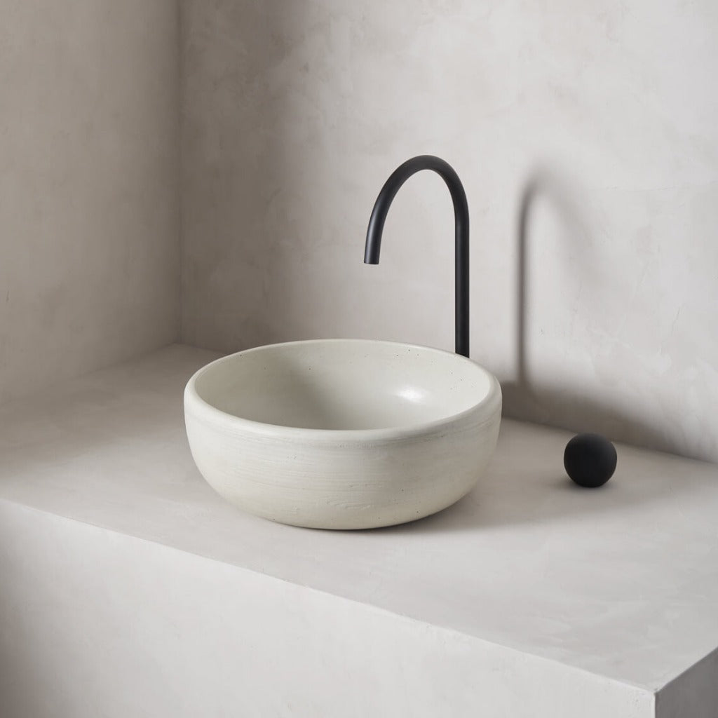 A modern and circular washbowl with softened curves and high, round-over basin walls