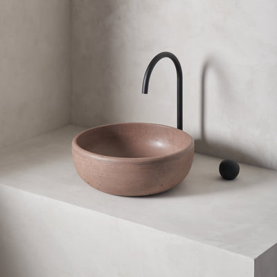 A modern and circular washbowl with softened curves and high, round-over basin walls
