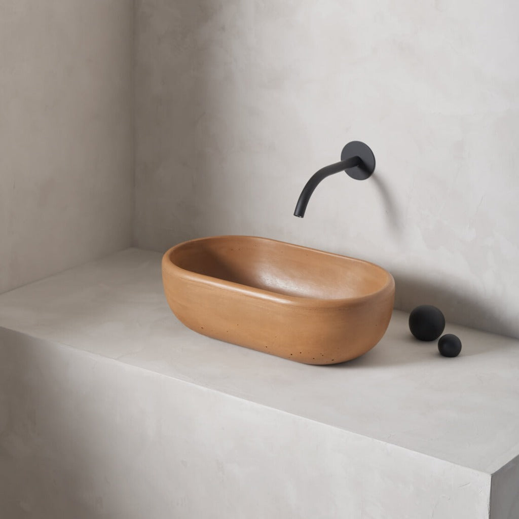 A petite and obround washbowl with softened curves and high, round-over basin walls