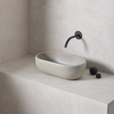A petite and obround washbowl with softened curves and high, round-over basin walls
