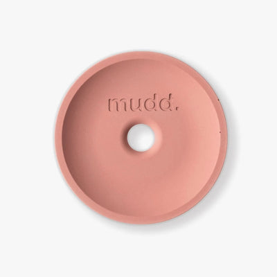 A pink bowl with the word mudd. concrete on it.