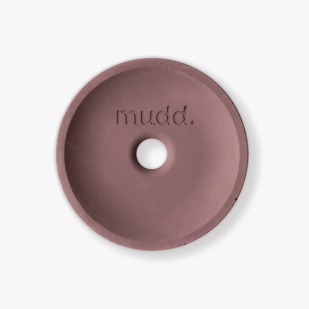 A pink donut with the word mudd. concrete on it.