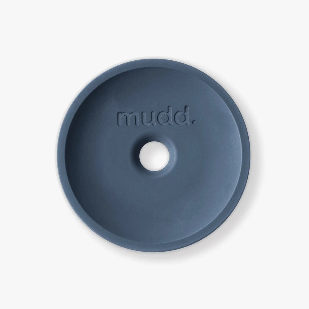 A blue bowl with the word mudd. concrete on it.