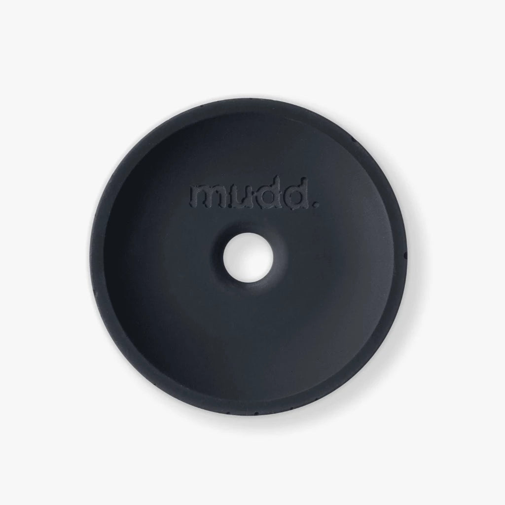 A black round object with the word mudd. concrete on it.