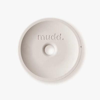 A white bowl with the word mudd. concrete written on it.