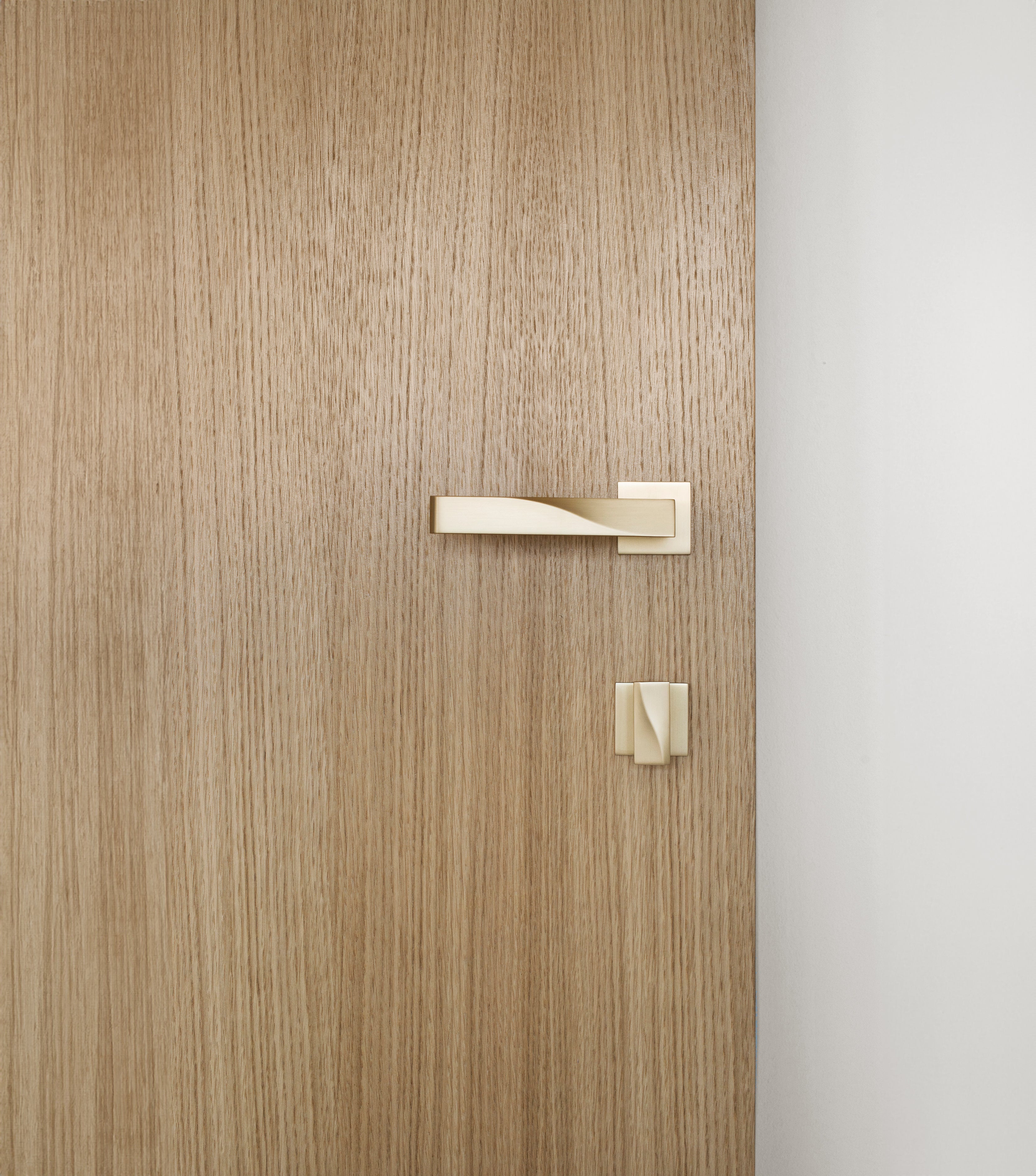 Beautiful wood grain door with brass door hardware including door lever and thumb turn