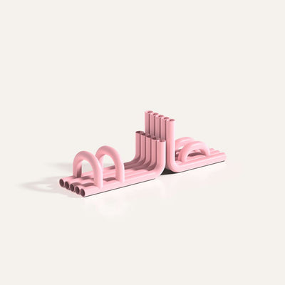 Pink TUBE Bookends photographed on an angle on a white background