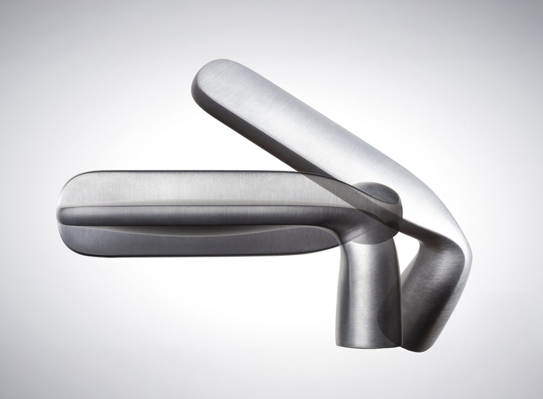 Verum hardware detail showing lever gesture resolved to the door plane