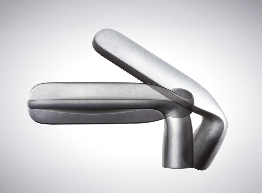 Verum hardware detail showing lever gesture resolved to the door plane